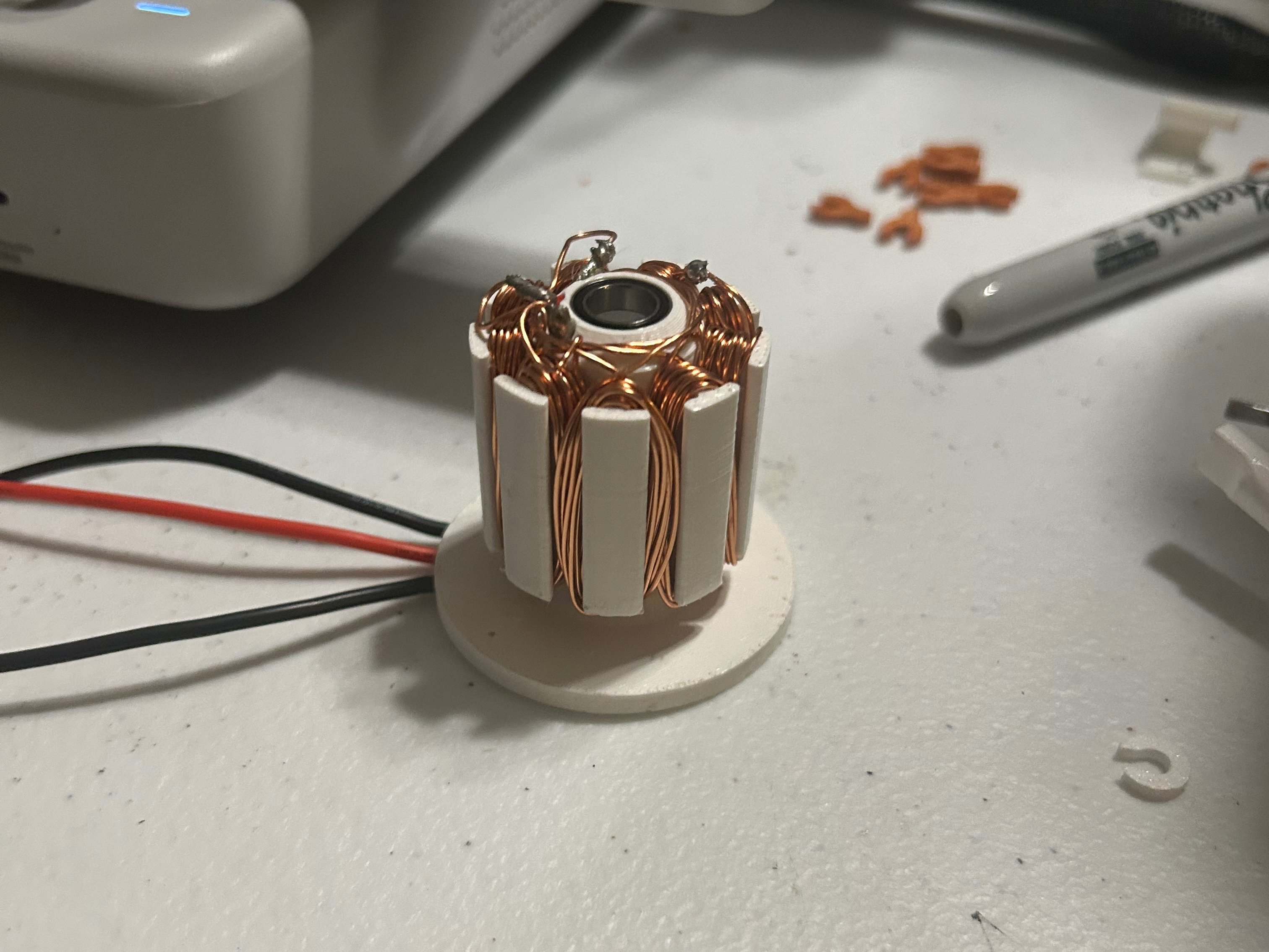 Assembled stator with press-fit bearings and wound coils